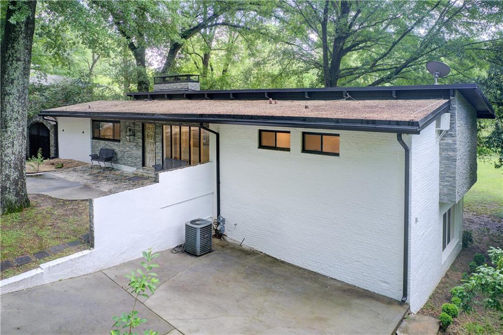 1676 Moores Mill Road Northwest Atlanta, GA 30327 - Photo 29 of 32 a view of a house with a tub and balcony
