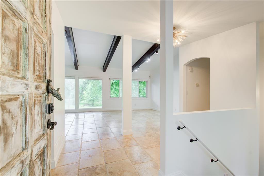 1676 Moores Mill Road Northwest Atlanta, GA 30327 - Photo 4 of 32 a view of a hallway with windows and entryway