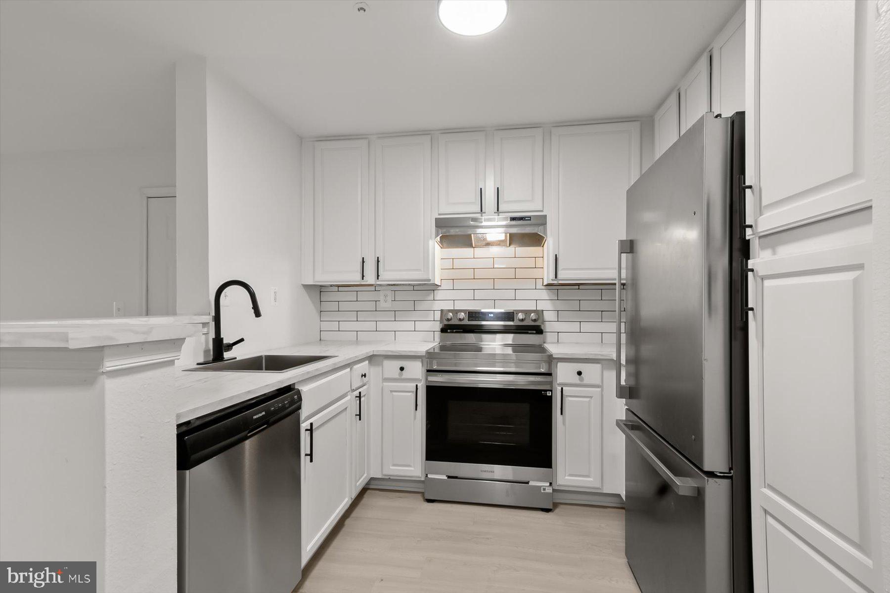 18521 Boysenberry Drive, Unit 242172 Gaithersburg, MD 20879 - Photo 1 of 43 a kitchen with stainless steel appliances granite countertop a sink stove and refrigerator