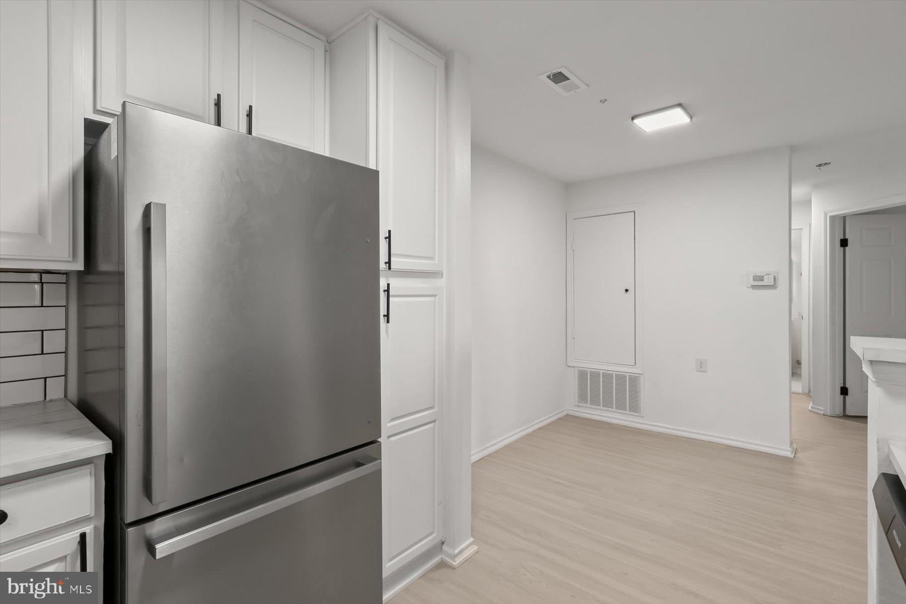 18521 Boysenberry Drive, Unit 242172 Gaithersburg, MD 20879 - Photo 11 of 43 a view of cabinets and refrigerator