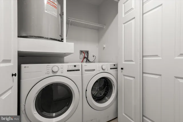 a bathroom with a toilet a sink a shower and mirror