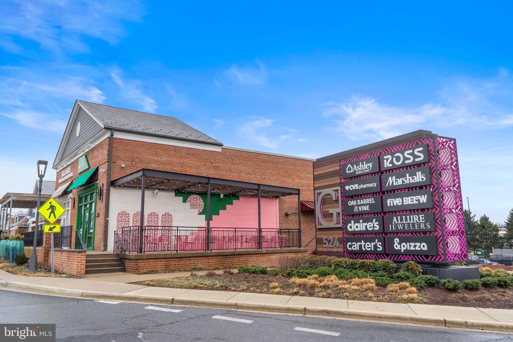 18521 Boysenberry Drive, Unit 242172 Gaithersburg, MD 20879 - Photo 40 of 43 a front view of a building with a garden