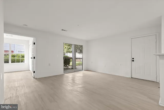 a view of an empty room with glass door