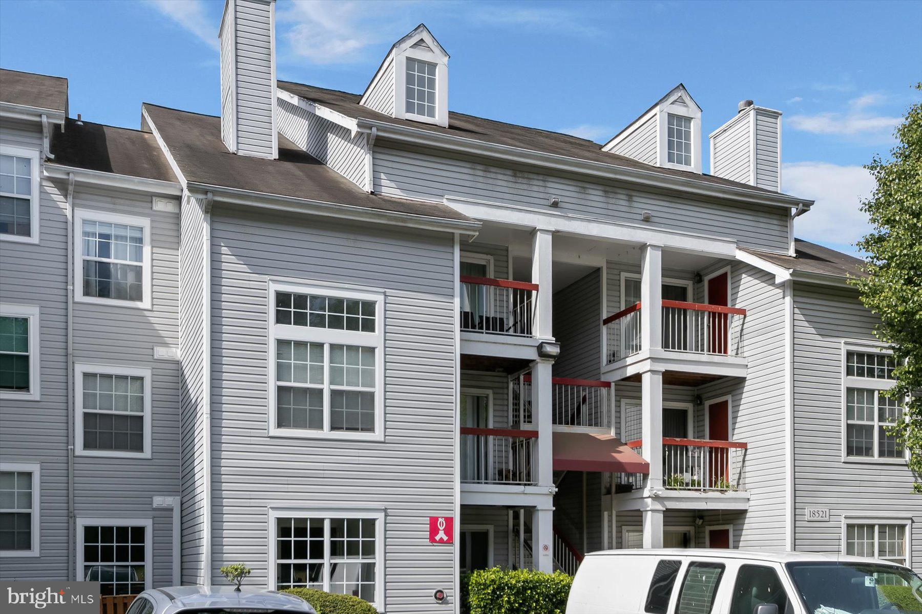 18521 Boysenberry Drive, Unit 242172 Gaithersburg, MD 20879 - Photo 43 of 43 a front view of a residential apartment building with a yard