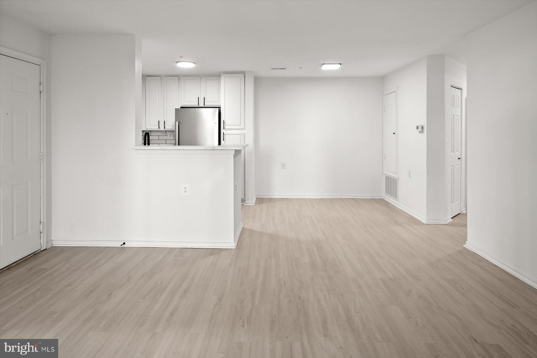 18521 Boysenberry Drive, Unit 242172 Gaithersburg, MD 20879 - Photo 6 of 43 a view of a kitchen with wooden floor
