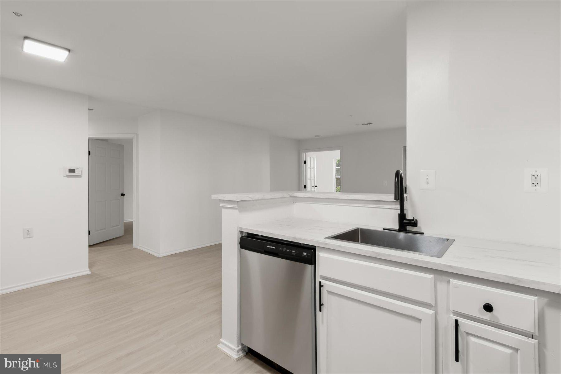 18521 Boysenberry Drive, Unit 242172 Gaithersburg, MD 20879 - Photo 10 of 43 a kitchen with a sink and cabinets