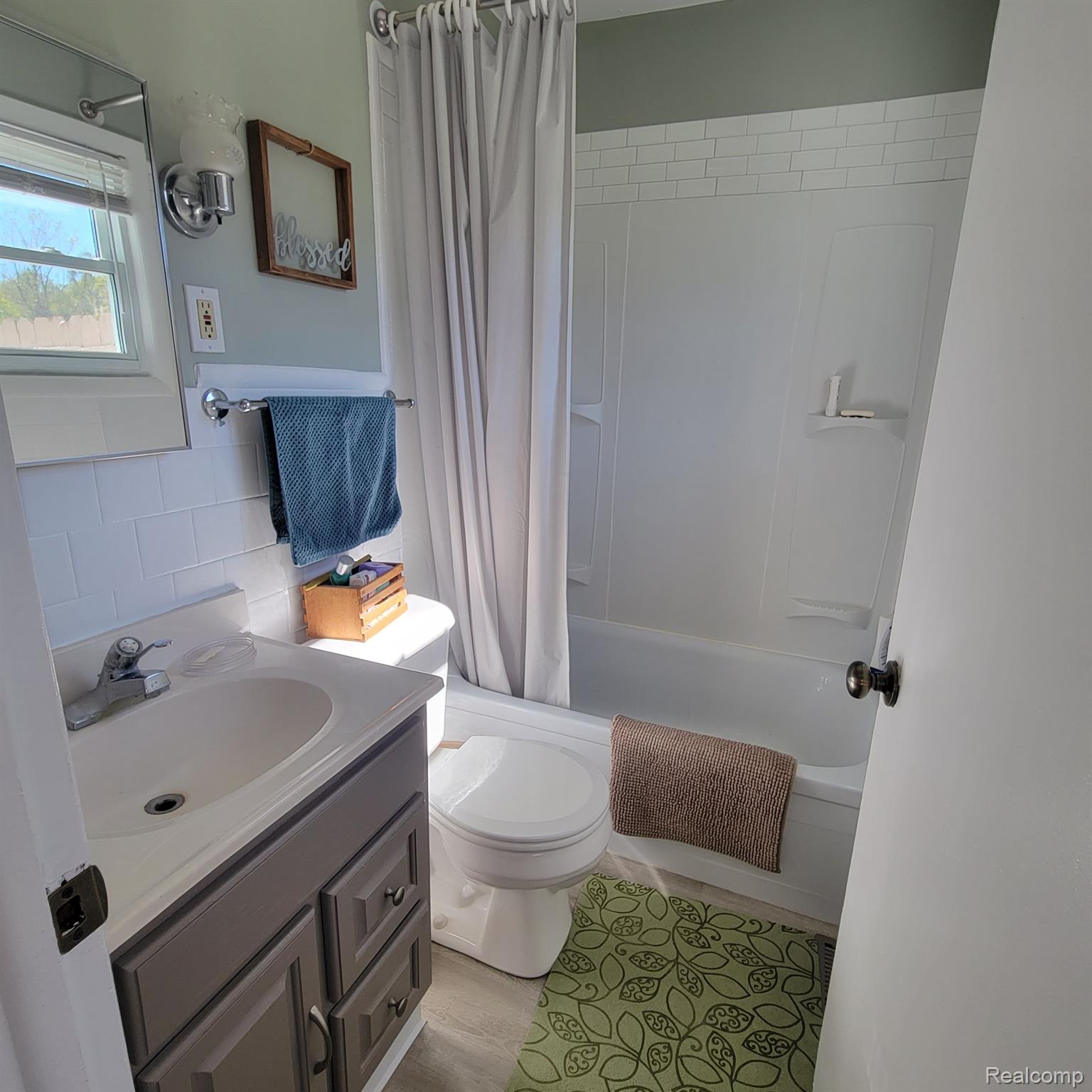 5782 Lyons Road Imlay City, MI 48444 - Photo 19 of 47 MAIN FLOOR BATH HAS NEW FLOORING AND TUB FIXTURES.
