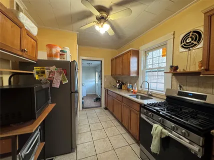 a kitchen with stainless steel appliances a stove a refrigerator and cabinets