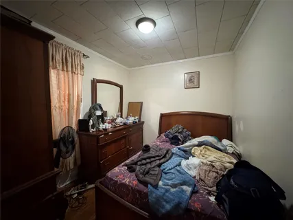 a bed sitting in a bedroom next to a window