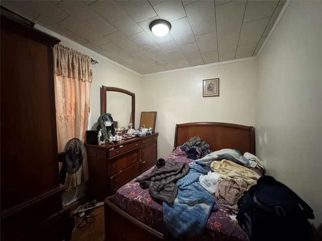 a bed sitting in a bedroom next to a window