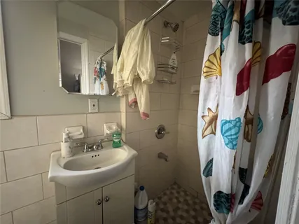 a bathroom with a sink and mirror with toilet