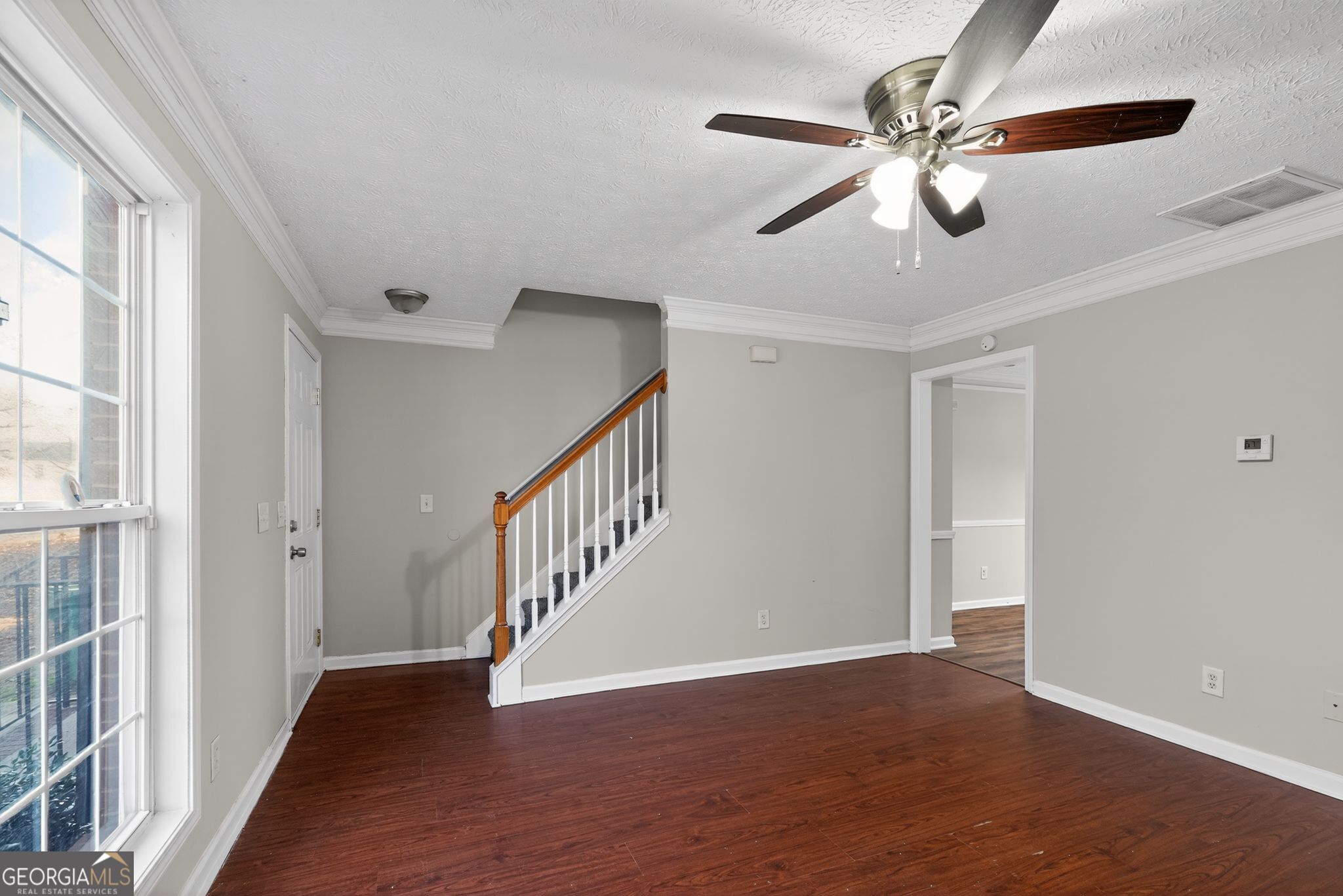 3969 Cress Way Run Decatur, GA 30034 - Photo 6 of 34 a view of an empty room with wooden floor and a ceiling fan
