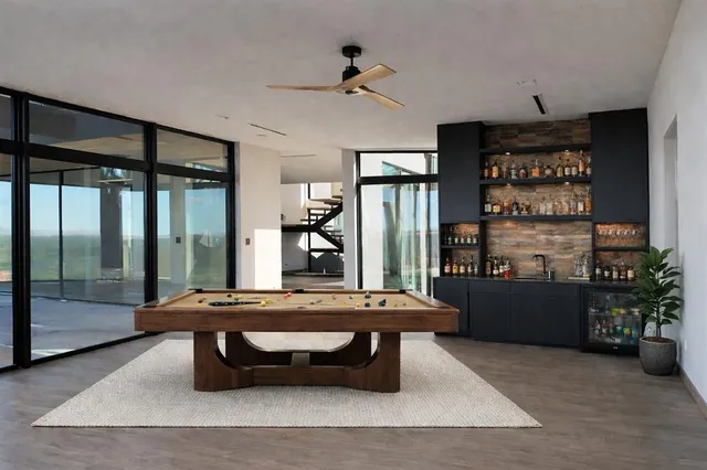 a view of a balcony with wooden floor and fence