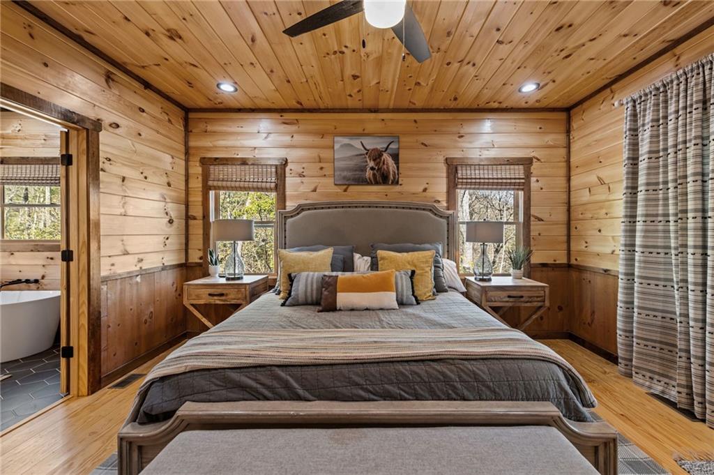 155 Peppermint Lane Epworth, GA 30541 - Photo 22 of 61 a bedroom with a bed and wooden floor