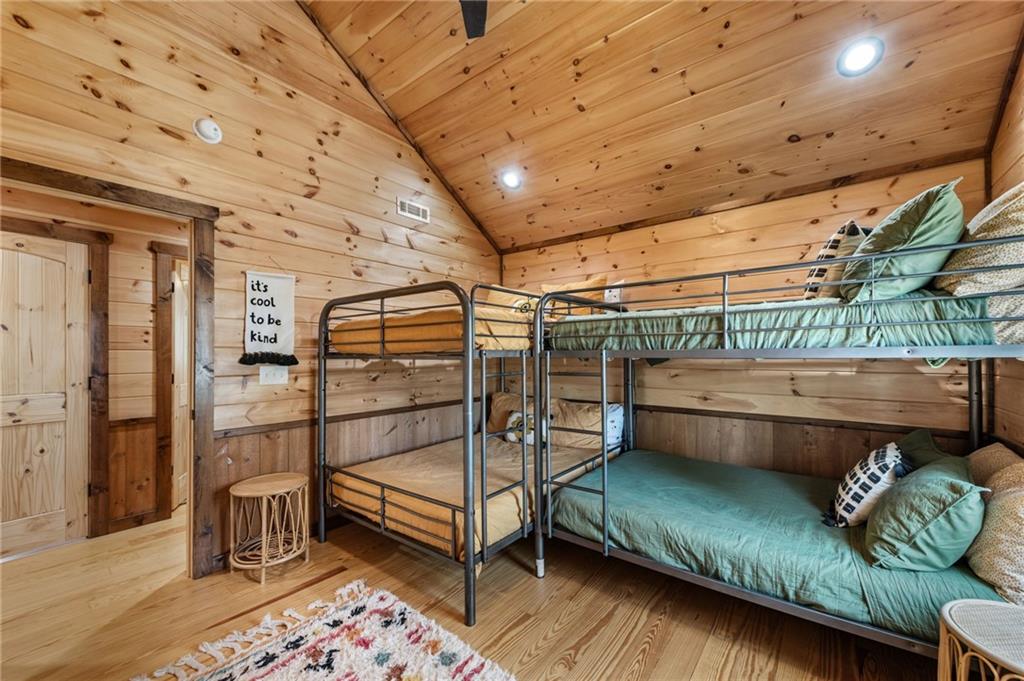 155 Peppermint Lane Epworth, GA 30541 - Photo 33 of 61 a bedroom with bed and a wooden floor