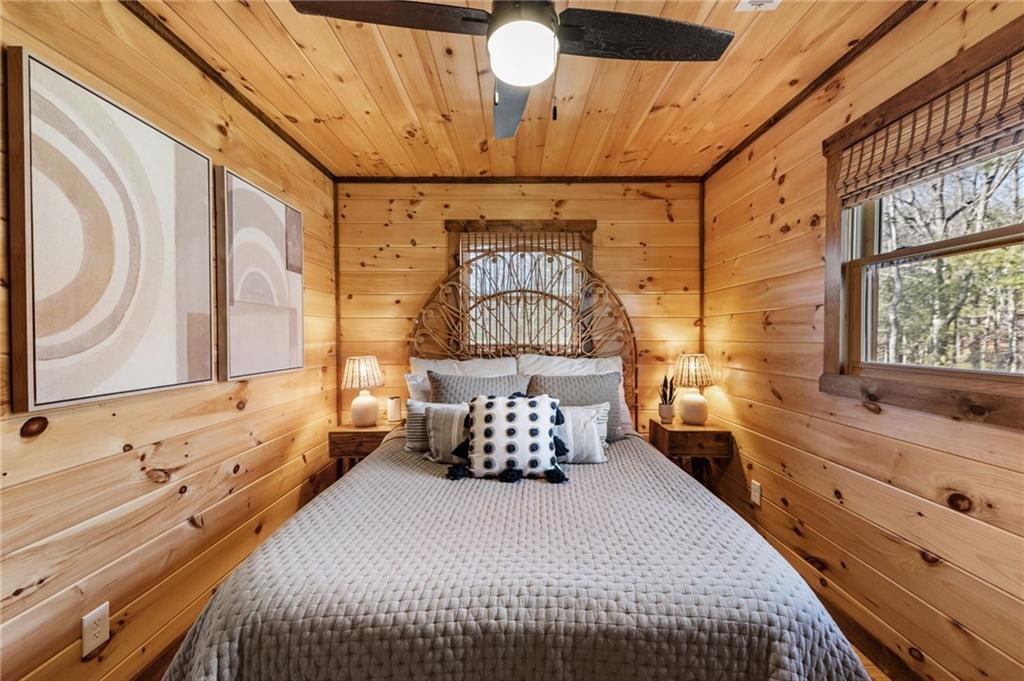 155 Peppermint Lane Epworth, GA 30541 - Photo 35 of 61 a bedroom with a bed and a chandelier