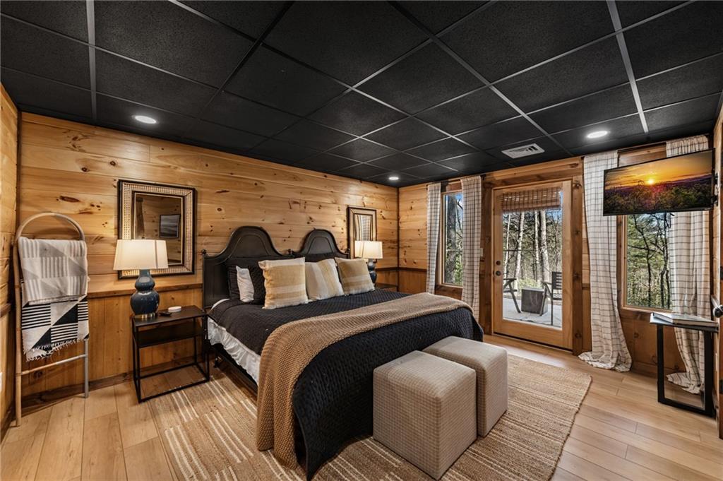 155 Peppermint Lane Epworth, GA 30541 - Photo 44 of 61 a spacious bedroom with a bed with wooden roof