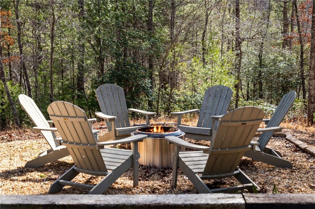 155 Peppermint Lane Epworth, GA 30541 - Photo 51 of 61 a view of a chairs and table in backyard