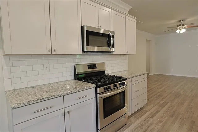 a bathroom with a sink vanity granite and a mirror