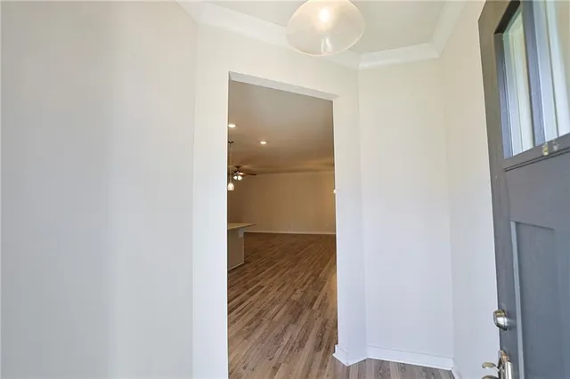 a view of a livingroom with wooden floor and a window