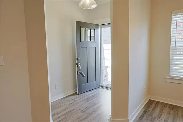 a view of kitchen with stainless steel appliances granite countertop a white stove top oven and white cabinets