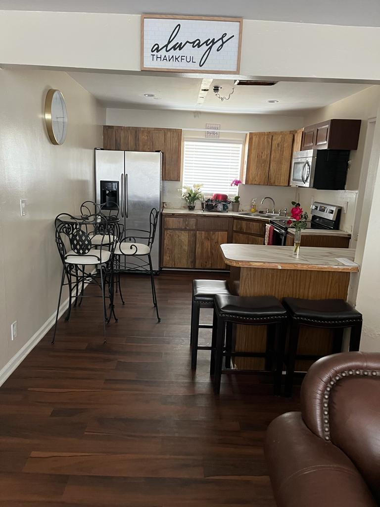 731 21st Street, Unit 12 West Palm Beach, FL 33407 - Photo 2 of 4 a living room with furniture and a flat screen tv
