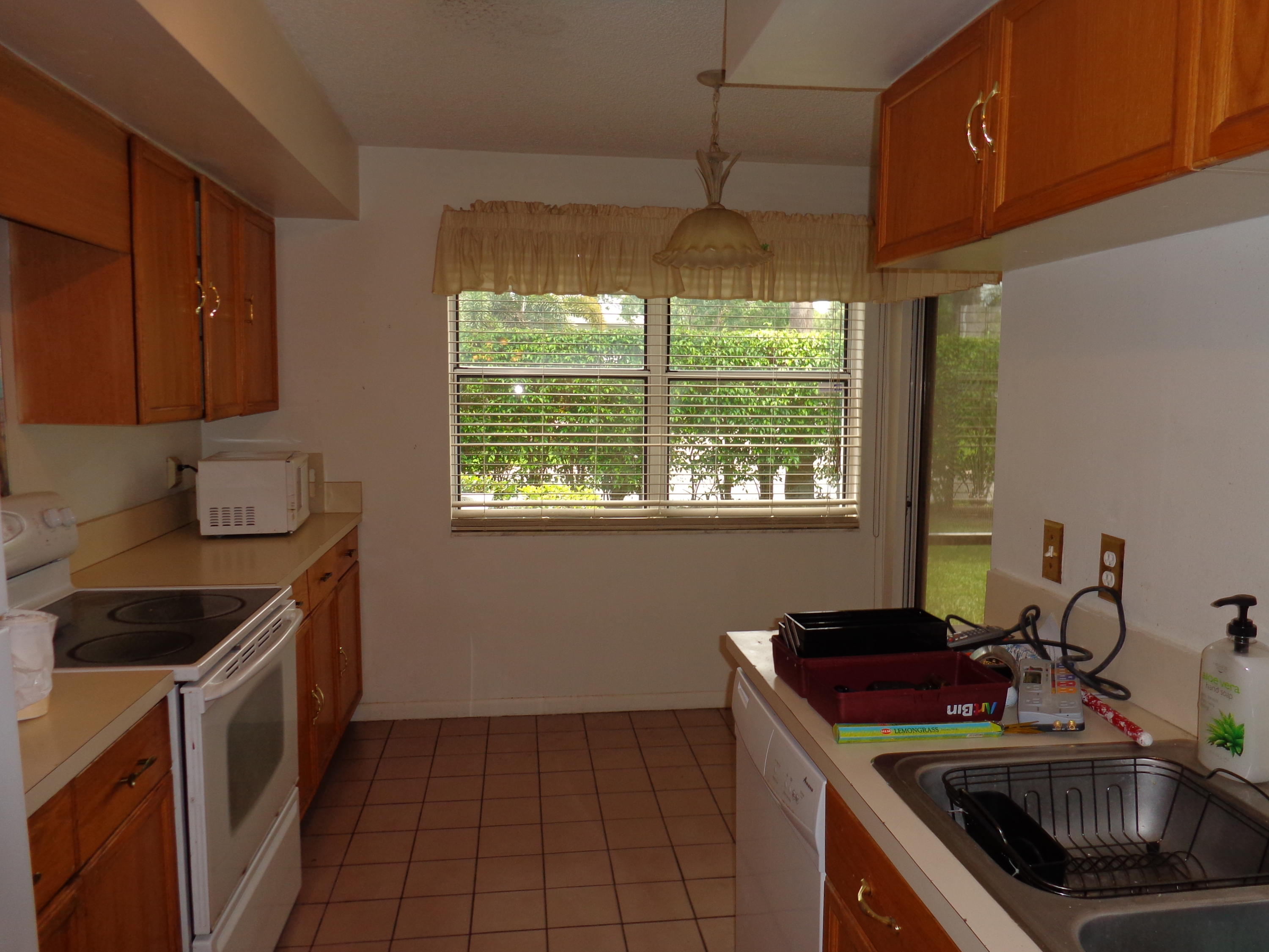 5322 Sapphire Valley Boca Raton, FL 33431 - Photo 4 of 7 a kitchen that has a sink and a stove