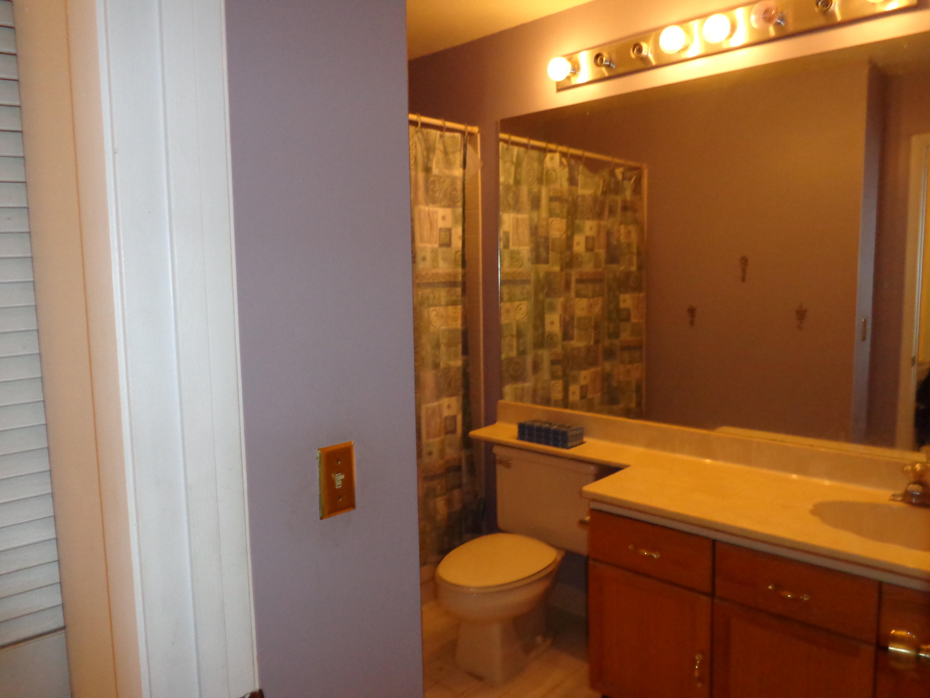 5322 Sapphire Valley Boca Raton, FL 33431 - Photo 6 of 7 a bathroom with a granite countertop toilet a sink and a shower