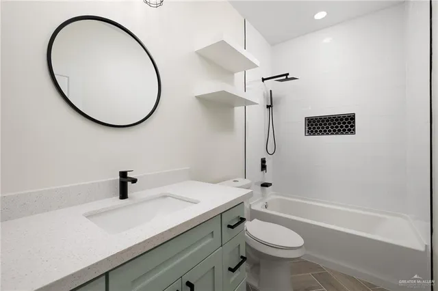 a bathroom with a sink a toilet and a mirror