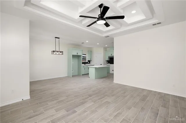 a view of a kitchen with a sink and wooden floor