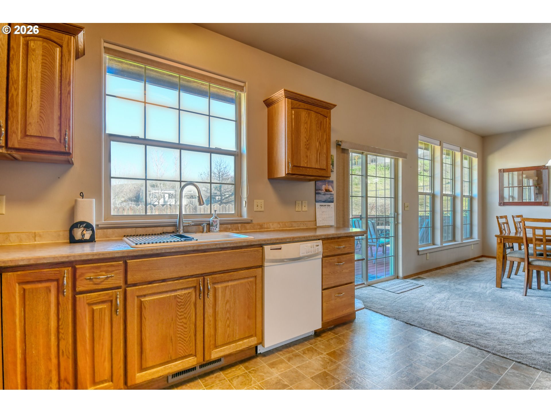 2175 Northwest Gilliam Avenue Pendleton, OR 97801 - Photo 12 of 36 a kitchen with granite countertop a stove a sink and a wooden cabinets