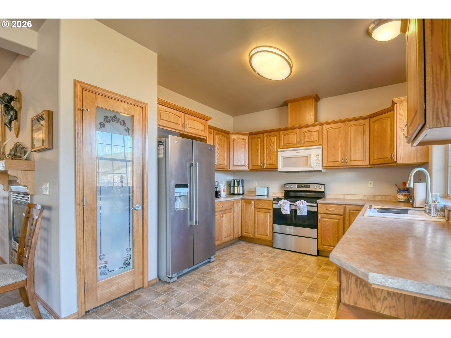 2175 Northwest Gilliam Avenue Pendleton, OR 97801 - Photo 13 of 36 a kitchen with stainless steel appliances granite countertop a refrigerator a stove top oven a sink and dishwasher