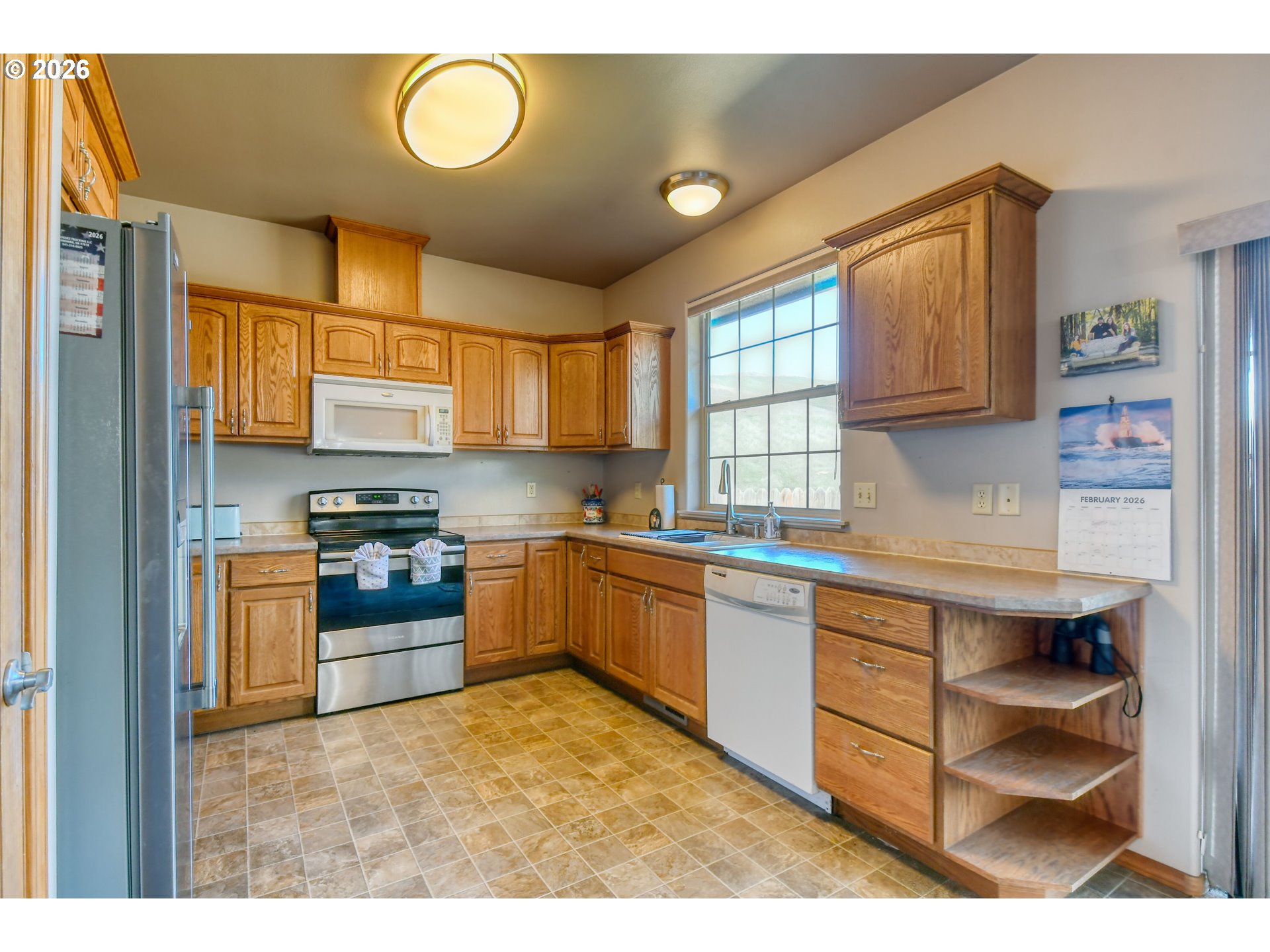 2175 Northwest Gilliam Avenue Pendleton, OR 97801 - Photo 14 of 36 a kitchen with stainless steel appliances granite countertop a stove sink and cabinets