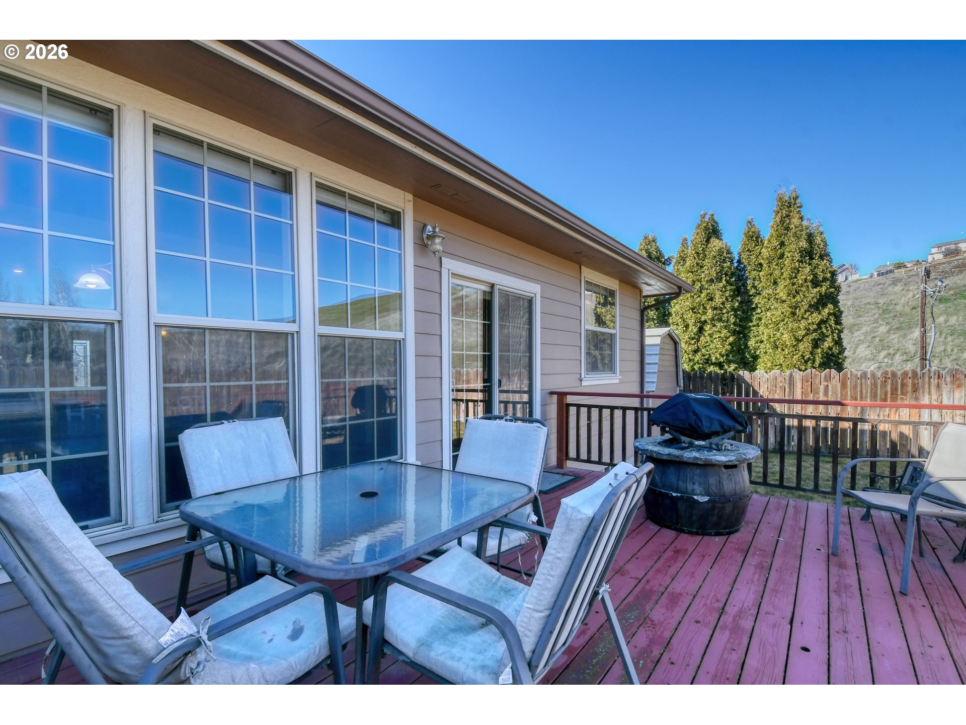 2175 Northwest Gilliam Avenue Pendleton, OR 97801 - Photo 29 of 36 a view of a deck with table and chairs and wooden floor