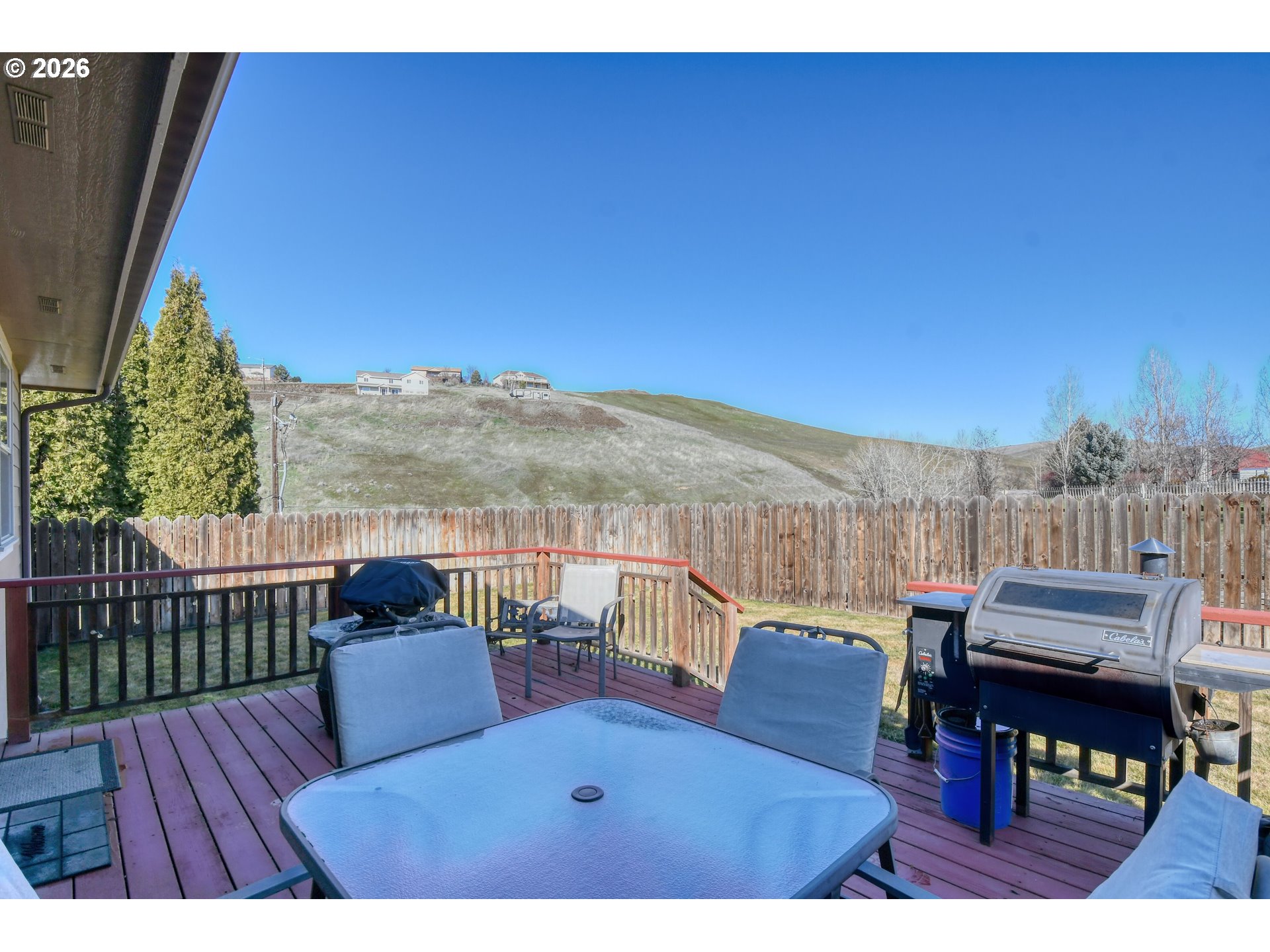 2175 Northwest Gilliam Avenue Pendleton, OR 97801 - Photo 30 of 36 a view of a balcony with table and chairs and wooden fence