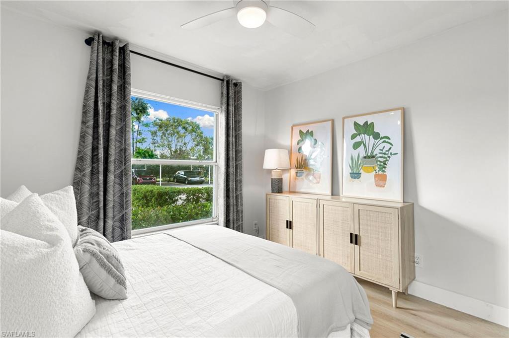 165 Wading Bird Circle, Unit M106 Naples, FL 34110 - Photo 16 of 23 a bedroom with a bed and a window