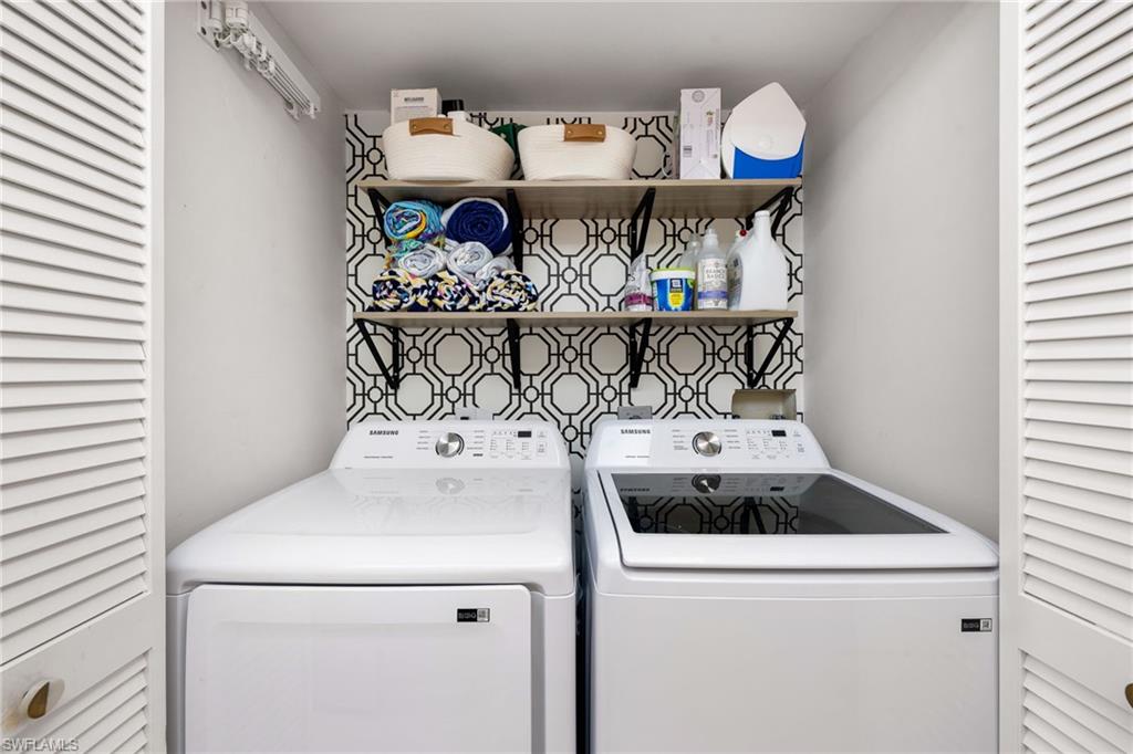 165 Wading Bird Circle, Unit M106 Naples, FL 34110 - Photo 18 of 23 a utility room with dryer and washer