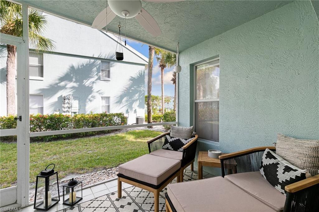 165 Wading Bird Circle, Unit M106 Naples, FL 34110 - Photo 19 of 23 a view of a balcony with chairs and a table