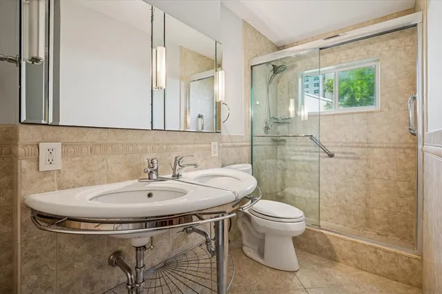 a bathroom with a sink and mirror with toilet