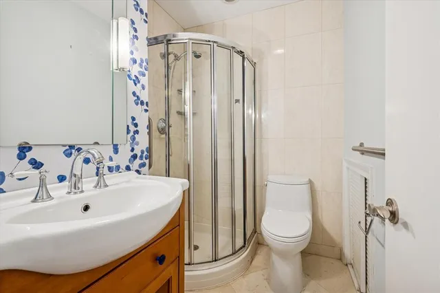 a bathroom with a sink a toilet and shower curtain