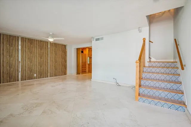 a view of an empty room with stairs