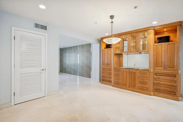 an empty room with window and cabinet