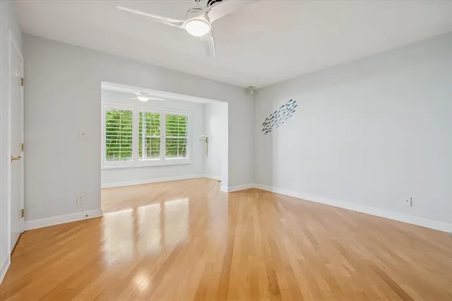 wooden floor in an empty room with a window