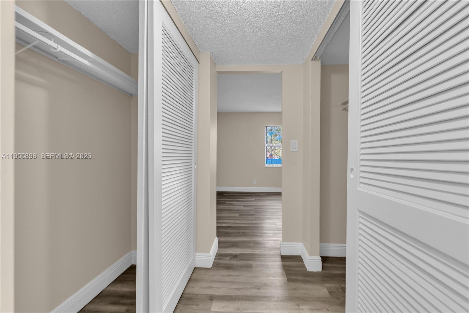 17901 Northwest 68th Avenue, Unit T206 Hialeah, FL 33015 - Photo 17 of 27 a view of a hallway with wooden floor and staircase