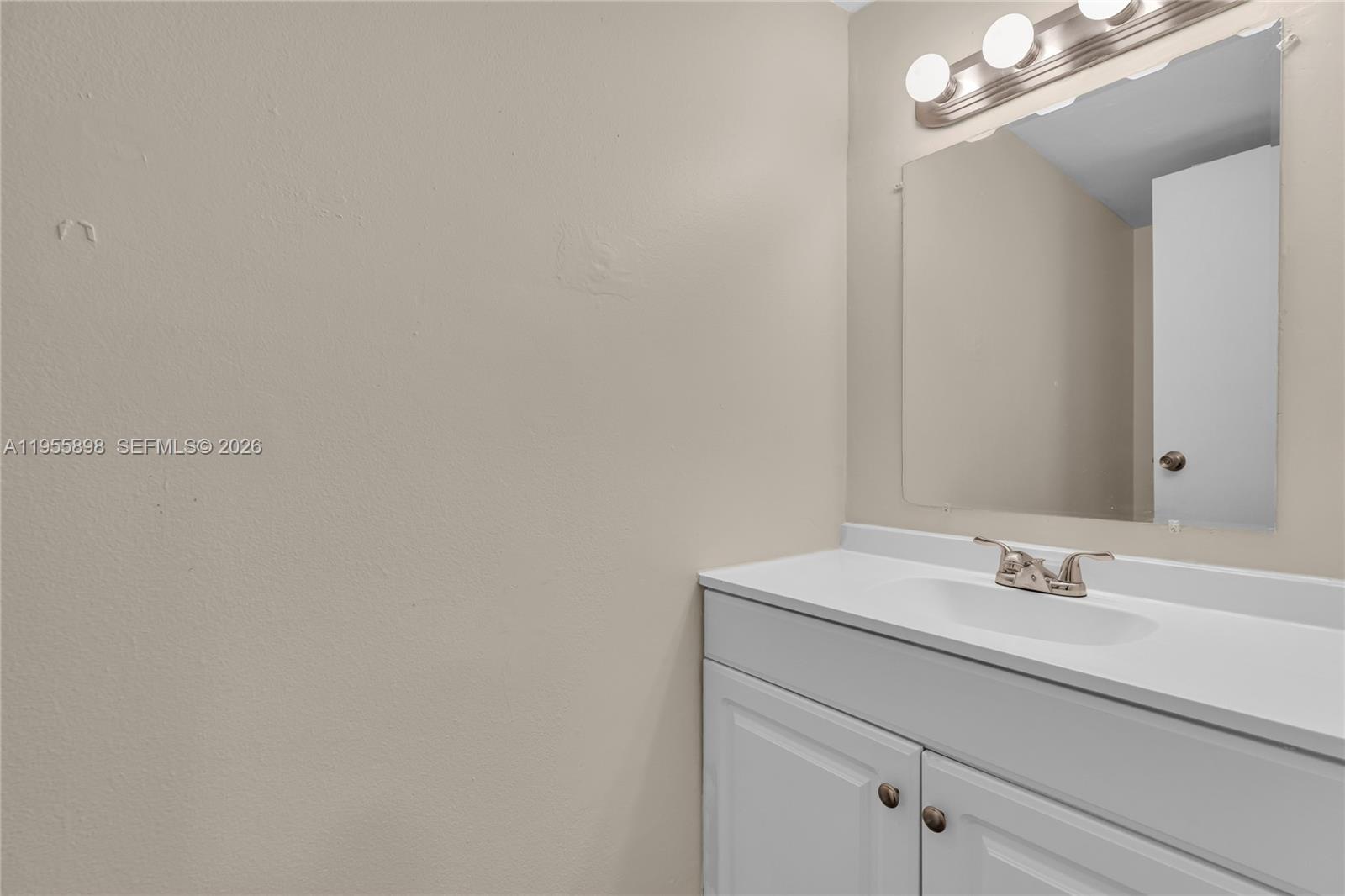 17901 Northwest 68th Avenue, Unit T206 Hialeah, FL 33015 - Photo 18 of 27 a bathroom with a sink and a mirror