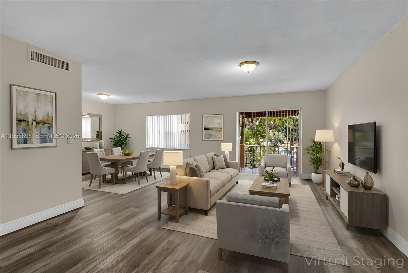 17901 Northwest 68th Avenue, Unit T206 Hialeah, FL 33015 - Photo 2 of 27 a living room with furniture and a flat screen tv