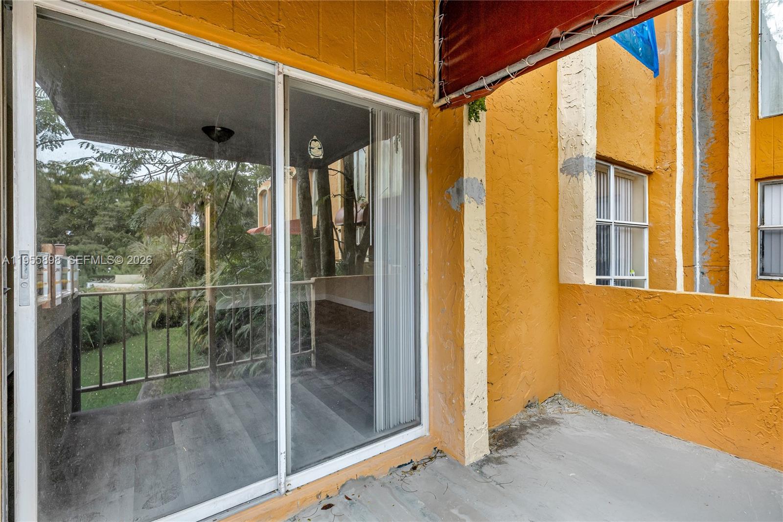 17901 Northwest 68th Avenue, Unit T206 Hialeah, FL 33015 - Photo 21 of 27 a view of a glass door and the window