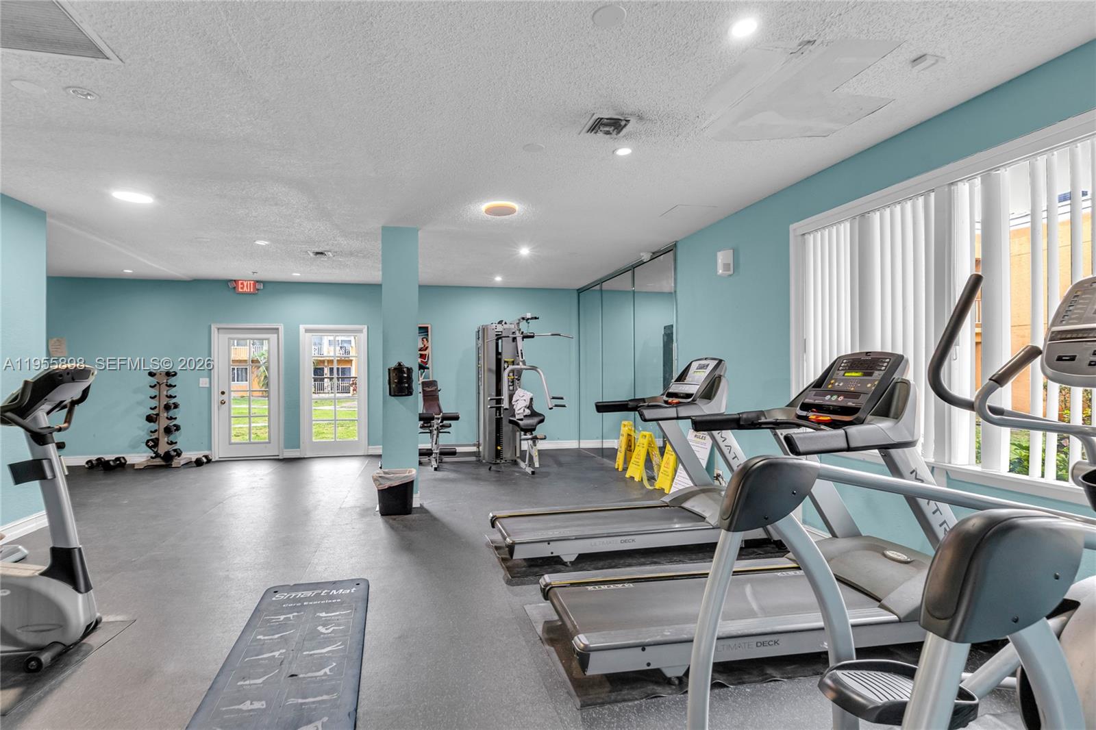 17901 Northwest 68th Avenue, Unit T206 Hialeah, FL 33015 - Photo 26 of 27 a view of a room with gym equipment
