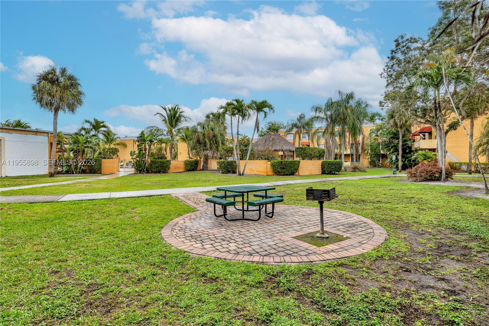 17901 Northwest 68th Avenue, Unit T206 Hialeah, FL 33015 - Photo 27 of 27 a view of a fountain in a yard with palm trees