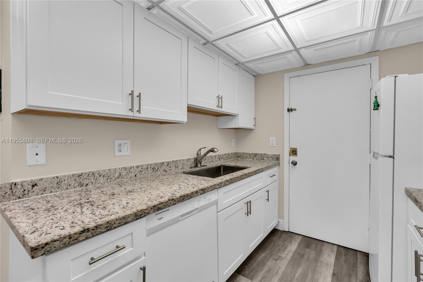 17901 Northwest 68th Avenue, Unit T206 Hialeah, FL 33015 - Photo 8 of 27 a kitchen with granite countertop a sink stainless steel appliances and cabinets